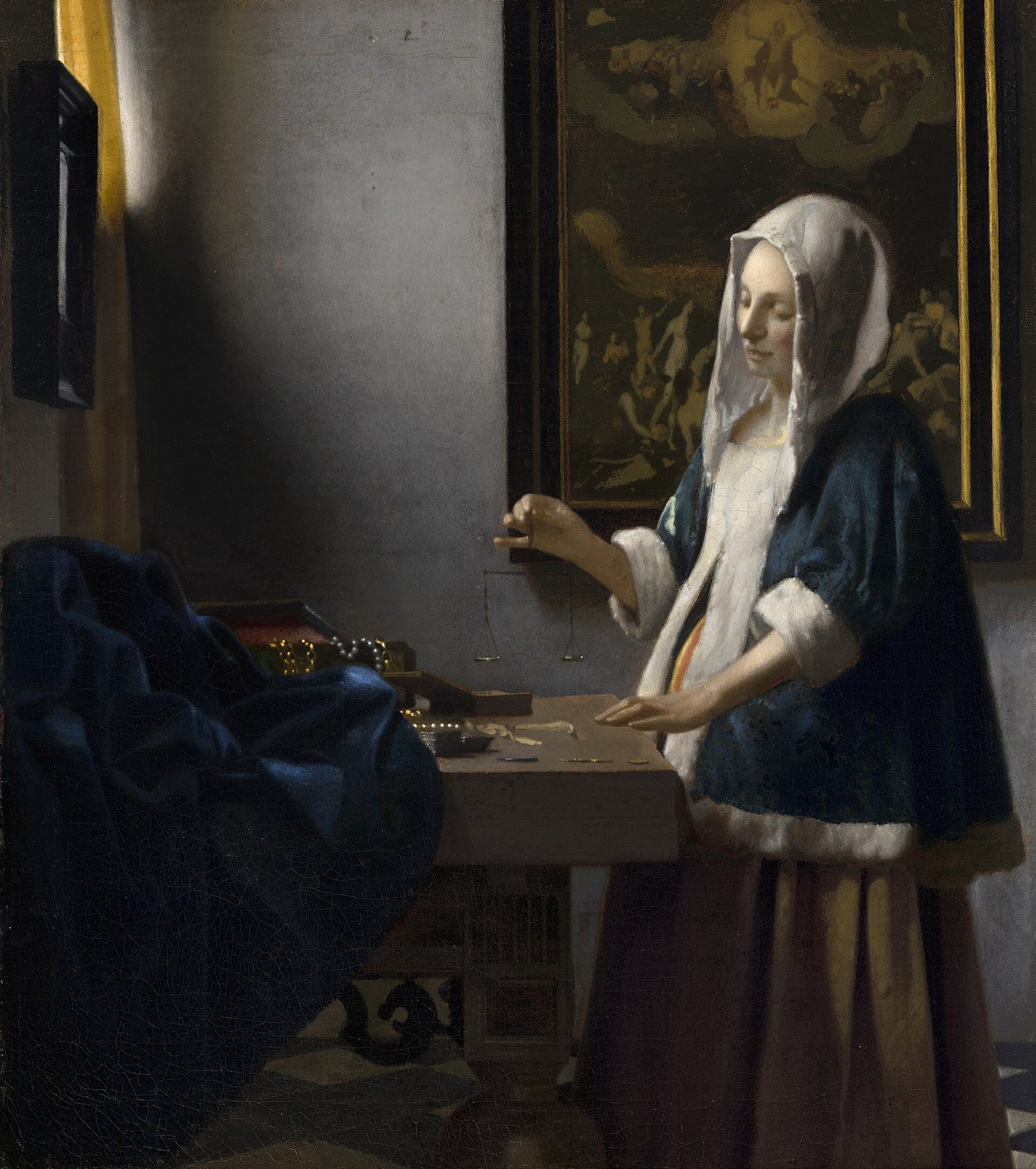 A painting of a woman in a blue jacket and white headscarf, standing at a table by a window and holding up a small balance.